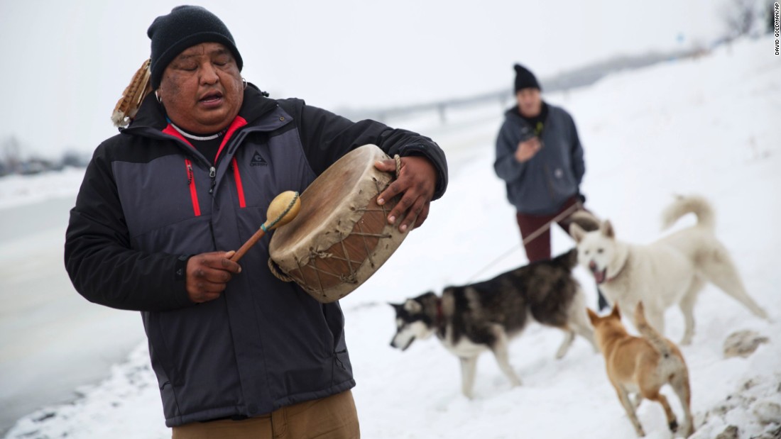 Dan Nanamkin of the Colville Nez Perce tribe drums a traditional song by the Cannonball River in Cannon Ball, North Dakota, on Thursday, December 1. Cannon Ball is the site of demonstrations against the &lt;a href=&quot;http://www.cnn.com/2016/09/07/us/dakota-access-pipeline-visual-guide/&quot; target=&quot;_blank&quot;&gt;Dakota Access Pipeline,&lt;/a&gt; a $3.7 billion project that would cross four states and change the landscape of the US crude oil supply. But the Standing Rock Sioux tribe says the pipeline would affect its drinking-water supply and destroy its sacred sites.