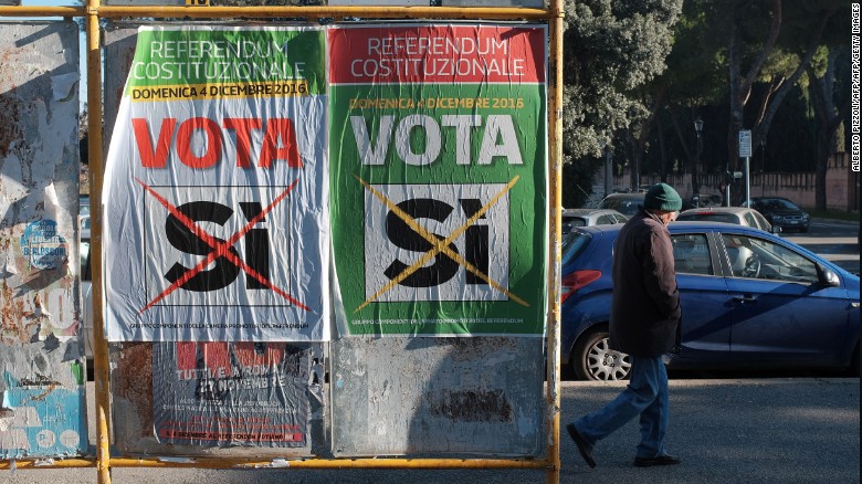 A man walks past posters calling for a &quot;Yes&quot; vote in Italy&#39;s constitutional referendum.