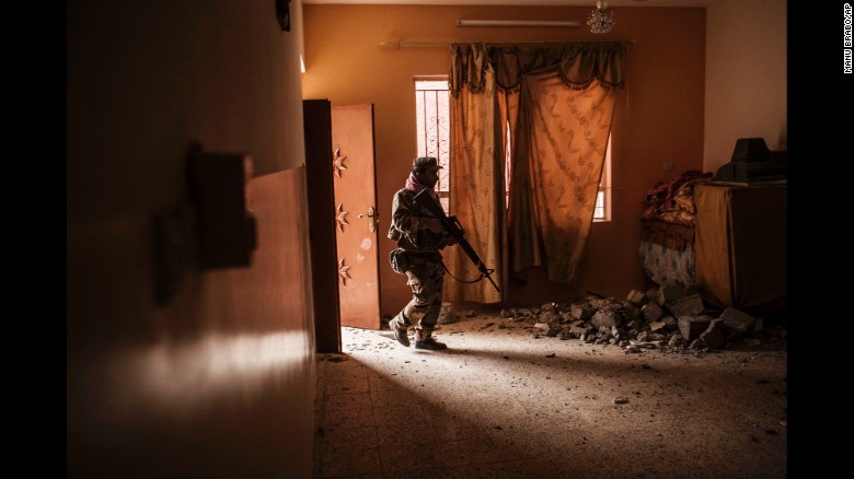 An Iraqi soldier searches for ISIS militants in a village outside Mosul earlier this week.