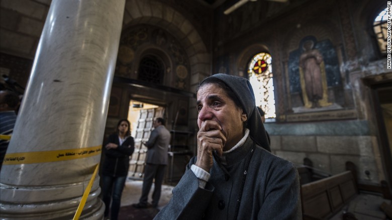 A nun reacts as Egyptian security forces inspect the scene of a bomb explosion at the Saint Peter and Saint Paul Coptic Orthodox Church on December 11, 2016, in Cairo&#39;s Abbasiya neighbourhood. 