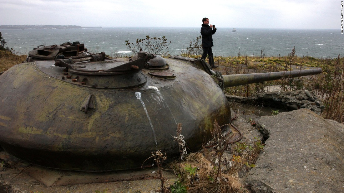 Then-Russian President and now Prime Minister Dmitry Medvedev walks near a Soviet-era fortifications during his visit to Kunashir, one of the Kuril islands, on November 1, 2010. 