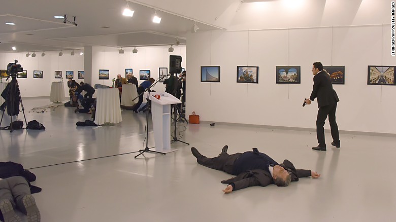 Graphic content / This picture taken on December 19, 2016 shows Andrey Karlov, the Russian ambassador to Ankara, lying on the floor after being shot by a gunman during an attack during a public event in Ankara.