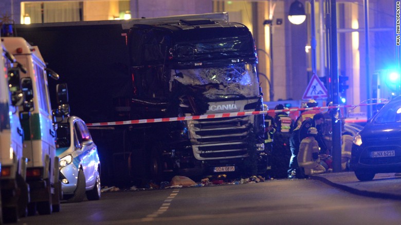 Rescue workers respond to the scene where a truck crashed into a Christmas market in Berlin on Monday, December 19. At least nine people were killed and at least 50 others were injured, police said.