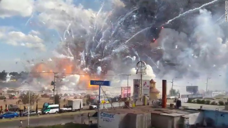 Fireworks explode from the San Pablito market in Tultepec, Mexico, on Tuesday, December 20. Authorities say dozens were killed in blasts at the market, which was especially busy with people buying fireworks for the holidays.