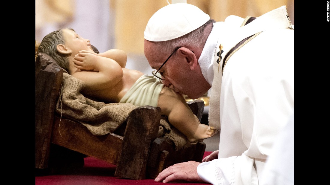 Pope Francis kisses a figure of baby Jesus during a Midnight Mass of Christmas in Saint Peter&#39;s Basilica at the Vatican, on December 25.