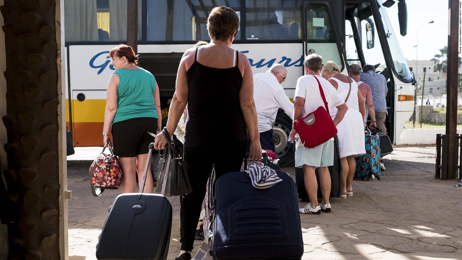 Tourists leave a hotel Wednesday in Banjul after a state of emergency went into effect.