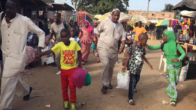 People walk to the ferry heading towards Senegal in Gambia&#39;s capital Banjul Tuesday on Jan. 17, 2017. 