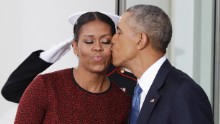 President Obama kisses the first lady as they await the arrival of President-elect Trump and his wife, Melania.