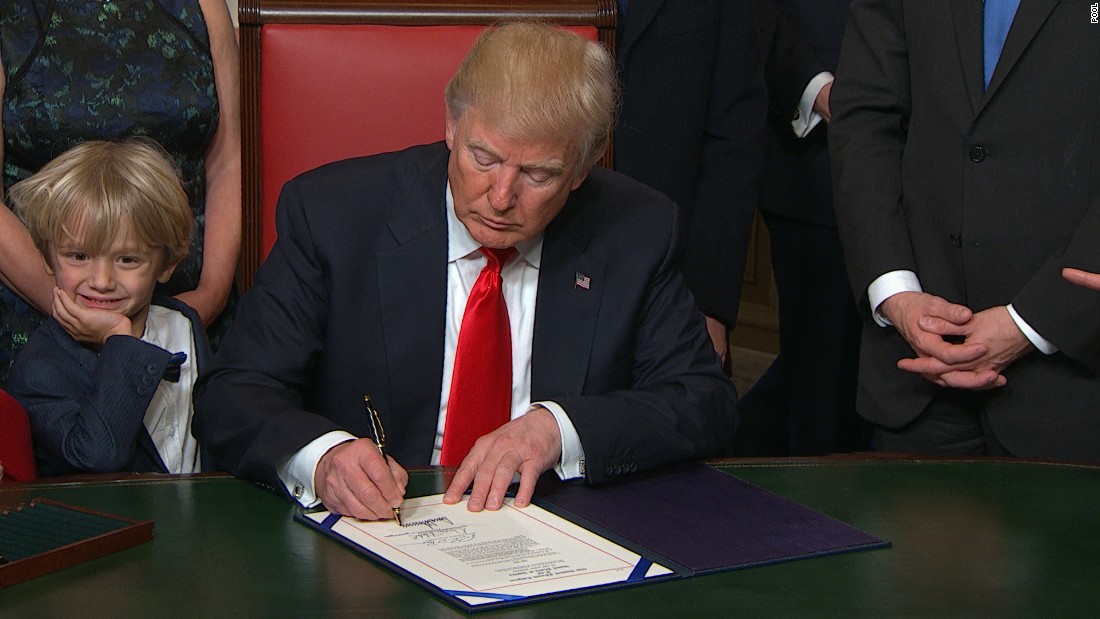 President Donald Trump signs first bill into law