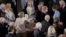 Newly sworn in President Trump shakes hands with Hillary Clinton.
