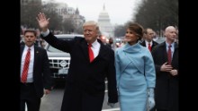 President Donald Trump waves as he walks on Pennsylvania Avenue with first lady Melania Trump during the Presidential Inaugural Parade on Friday, January 20.