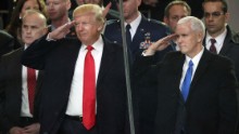 President Donald Trump and Vice President Mike Pence salute military personnel from the main reviewing stand in front of the White House during the Presidential Inaugural Parade.