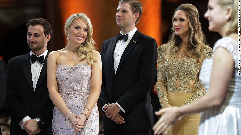 Tiffany Trump and her guest Ross Mechanic, and Eric Trump and his wife Lara Yunaska watch as US President Trump cuts a cake. 