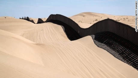 In California, part of the US-Mexico border fence snakes over sand dunes that sometimes wash over the fence.