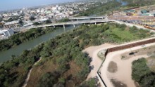 In Hidalgo, Texas, the border fence runs by a bridge that connects the United States and Mexico.