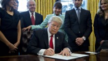 U.S. President Donald Trump signs an executive order in the Oval Office of the White House January 30, 2017 in Washington, DC. Trump said he will 