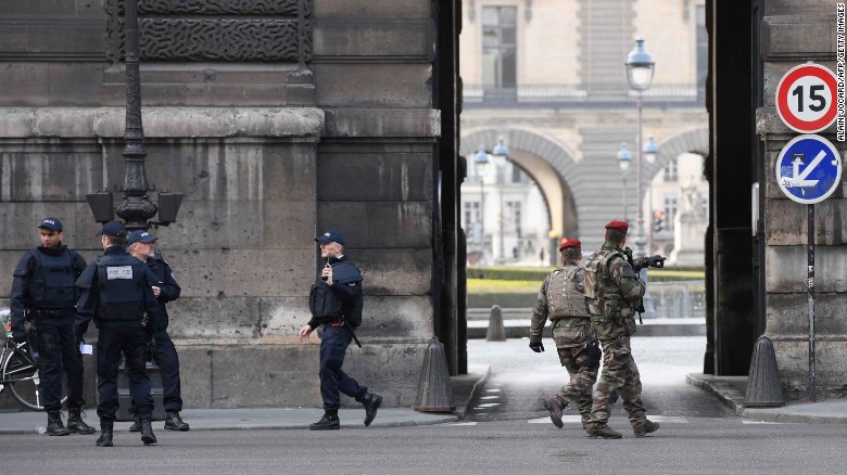 French police officers and soldiers patrol in front of the Louvre museum on Friday after a security incident.