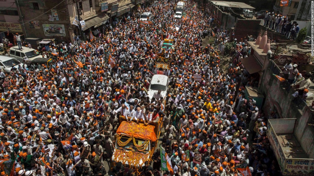 BJP leader Narendra Modi waves to supporters in Varanasi from an open truck in April 2014.