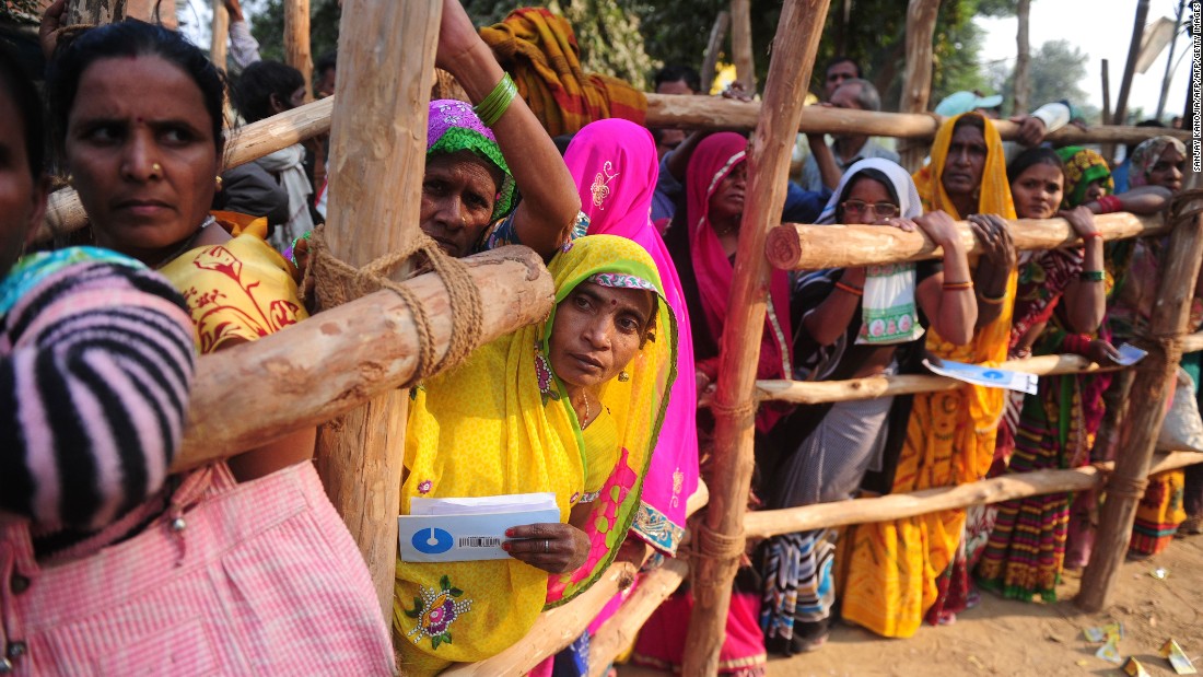 Villagers wait outside a bank to deposit and exchange large rupee notes on the outskirts of Allahabad in Uttar Pradesh. 