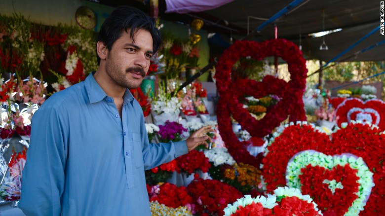 Sultan Zaib in front of his garlands of roses.