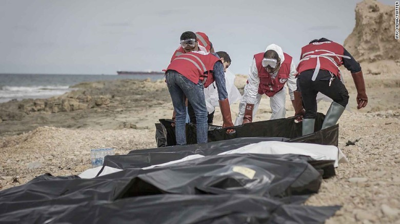 Libyan Red Crescent volunteers collect the bodies of men who drowned and were washed ashore. 