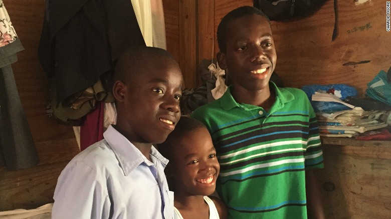 Monley (center) with his brothers Christoper (left) and Moise (right).