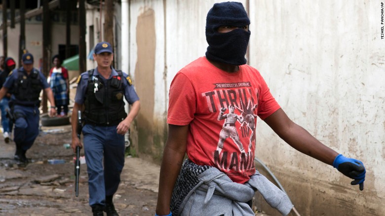 Police follow a South African protester in  the latest wave of anti-immigrant protests to break out in the capital. 