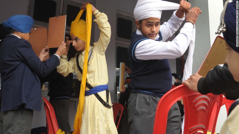 Young Indian Sikhs participate in a turban tying competition in 2014.