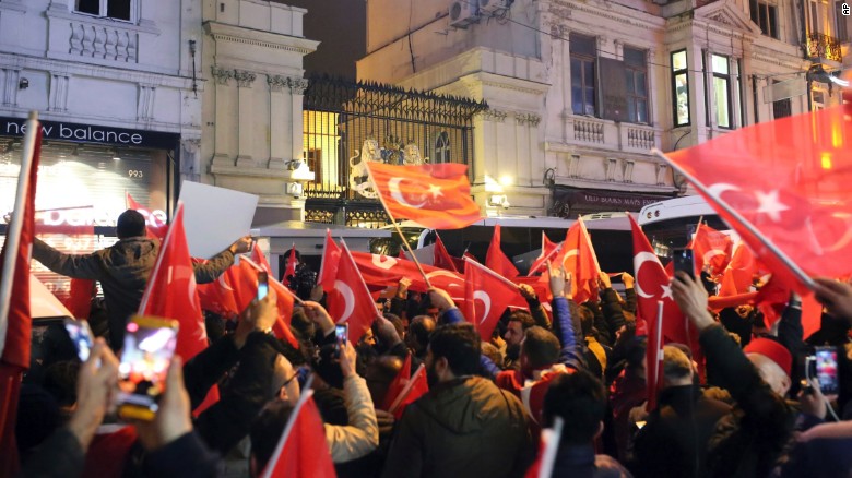 Supporters of Turkey&#39;s president wave flags outside the Dutch consulate in Istanbul on Sunday.