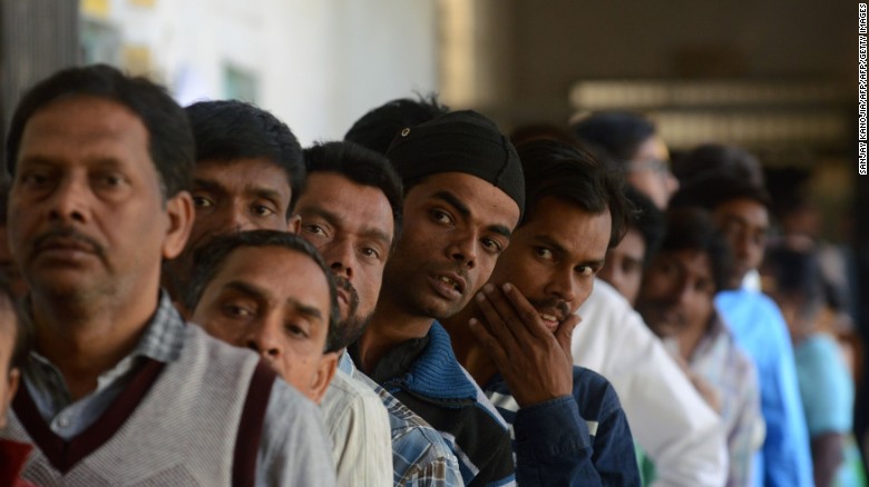 Indian voters wait in line at a polling station in the Naini area on the outskirts of Allahabad during the fourth phase of Uttar Pradesh state assembly elections on February 23.