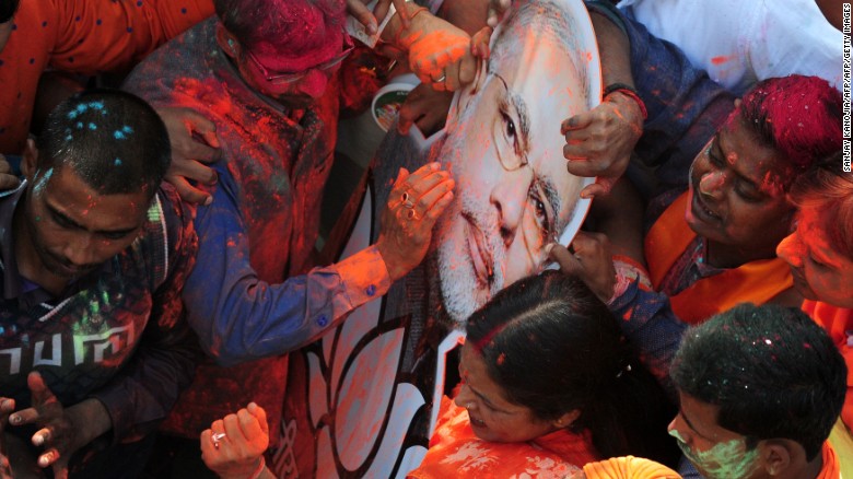 Indian supporters of the Bharatiya Janata Party (BJP) celebrate outside the party office as state assembly votes are counted in Lucknow on March 11, 2017.
