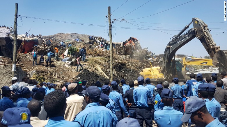 Police officers secure the scene after the landslide at the landfill, as excavators aid rescue efforts on the outskirts of Addis Ababa on Sunday, March 12, 2017.