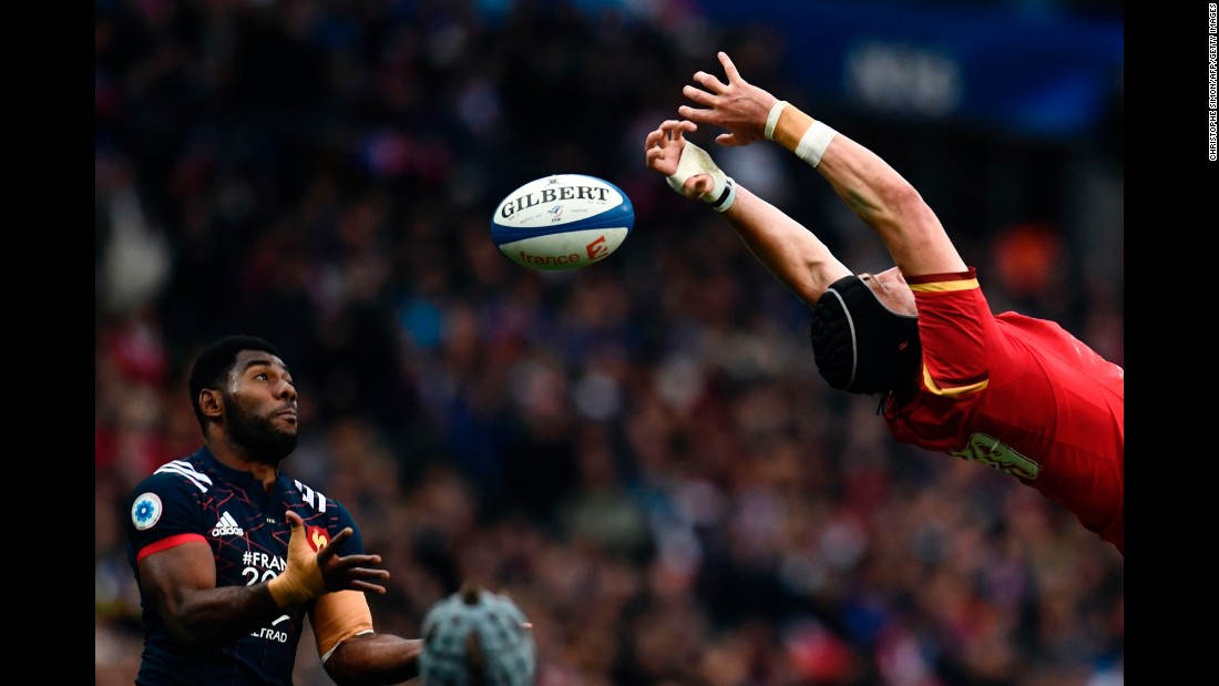 French rugby player Noa Nakaitaci, left, tries to catch the ball as it slips past Wales&#39; Samson Lee during a Six Nations match on Saturday, March 18.