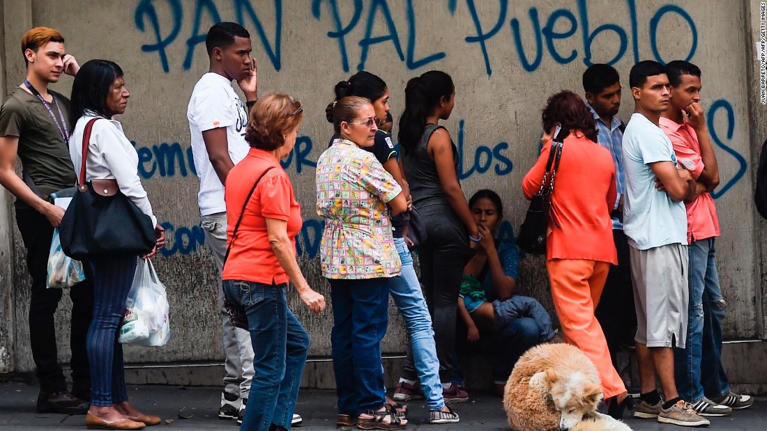 People line up to buy bread in Caracas amid shortages and skyrocketing prices on all types of goods. 