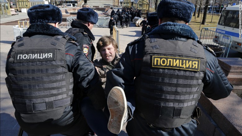 Police detain a protester in central Moscow on Sunday.