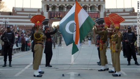 Indian and Pakistani border guards engage in a daily flag-lowering ceremony.