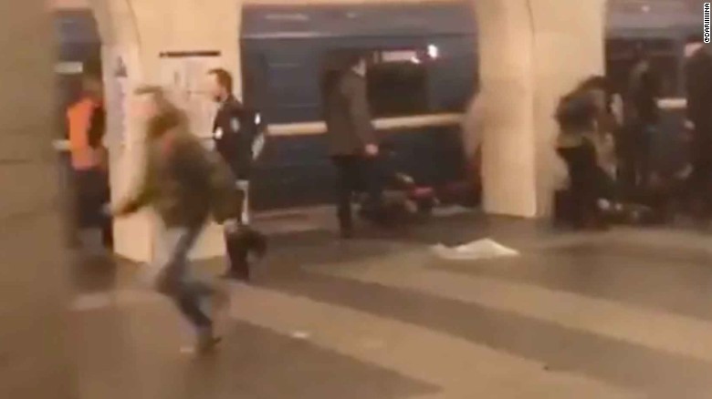 People run after an explosion at a St Petersburg metro station.