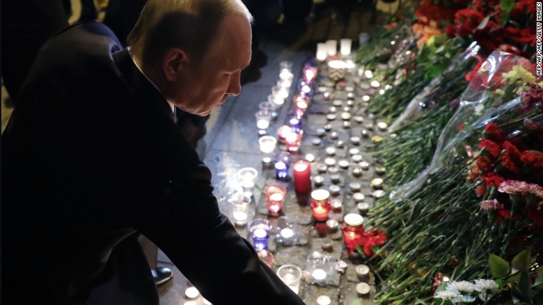 Russian President Vladimir Putin places flowers in memory of victims at the Technological Institute metro station in St. Petersburg.