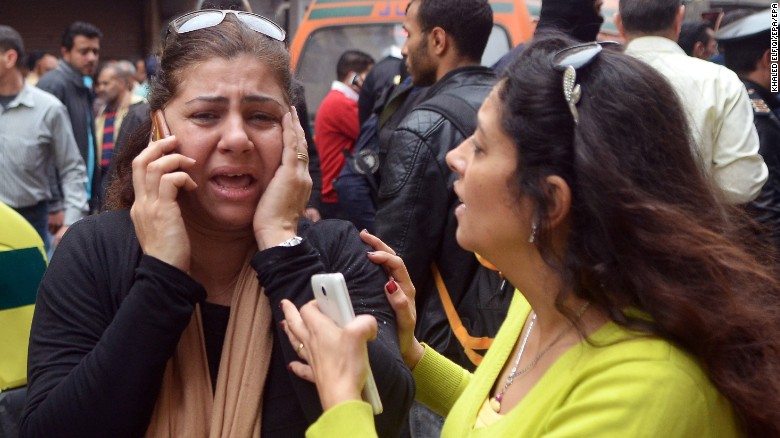 Women try to reach loved ones after the attack in Alexandria. 