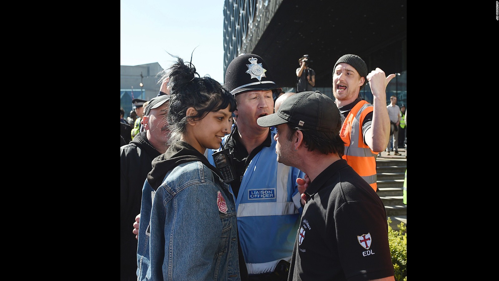 An English Defence League member, right, and a woman identified Saffiyah Khan, are pictured during an EFL rally in Birmingham, England, on Saturday.