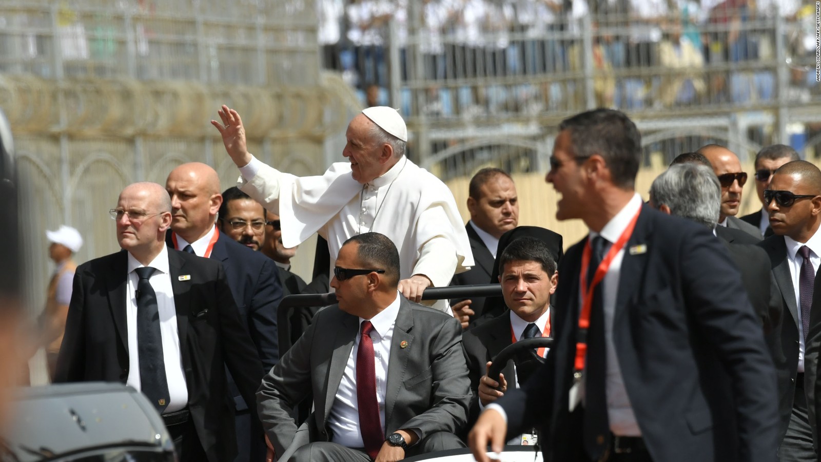 Pope Francis is surrounded by security at the Air Defense Stadium in Cairo.