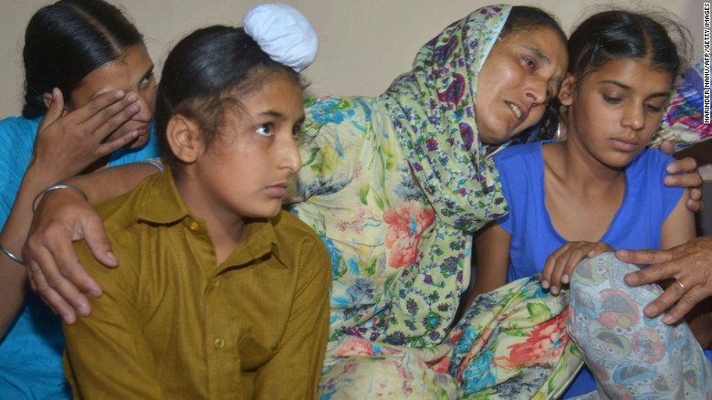 Wife of Indian army soldier Paramjit Singh cries with her  
children at their residence in Vein Pein village on May 1, 2017.  