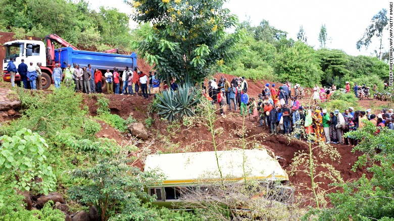 People look at the wreckage of a bus crash in Tanzania. 