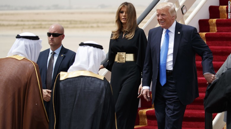 President Trump, accompanied by first lady Melania Trump, smiles at Saudi King Salman at a welcome ceremony Saturday at the Royal Terminal of King Khalid International Airport.