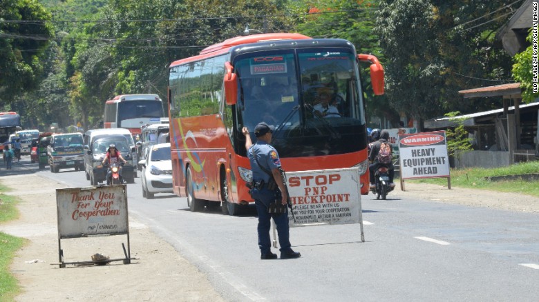 A police officer mans a checkpoint on a highway in Iligan City on the southern island of Mindanao on May 24.
