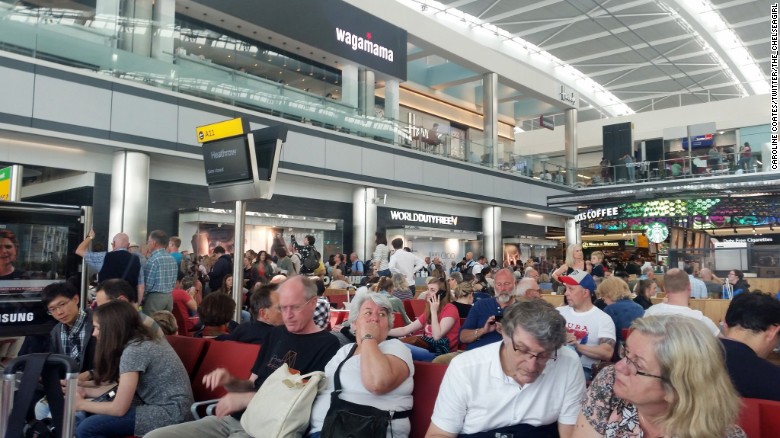 Passengerswait Saturday at London&#39;s Heathrow Airport as British Airways experiences computer problems.