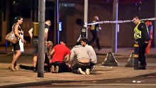 A person is treated for injuries near London Bridge.