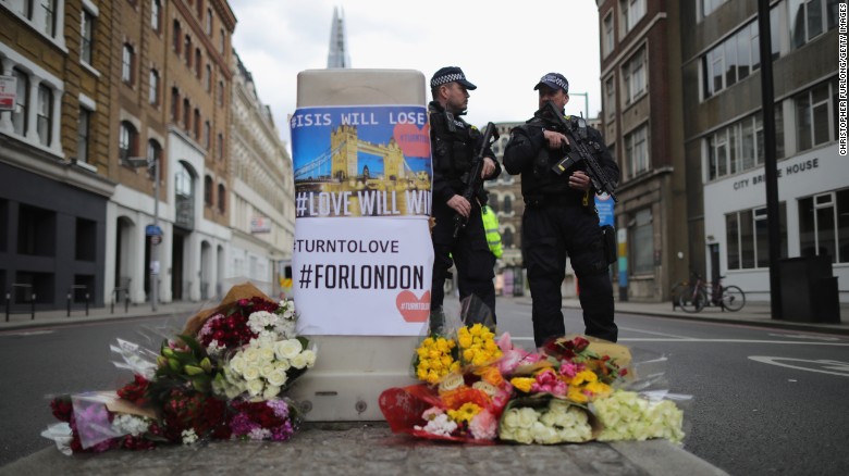 LONDON, ENGLAND - JUNE 04: Armed police stand guard in front of floral tributes on Southwark Street near the scene of last night&#39;s terrorist attack on June 4, 2017 in London, England. Police continue to cordon off an area after responding to terrorist attacks on London Bridge and Borough Market where 7 people were killed and at least 48 injured last night. Three attackers were shot dead by armed police. (Photo by Christopher Furlong/Getty Images)