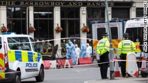 Investigators work the scene along Borough High Street on Monday. 