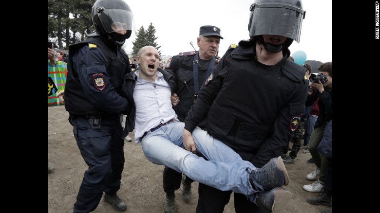 Police detain a protester in St. Petersburg on Monday.